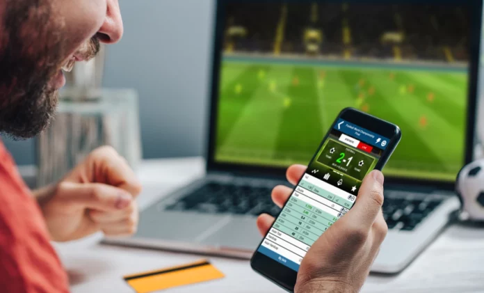 partido de futbol, apuestas online, fanático celebra victoria
